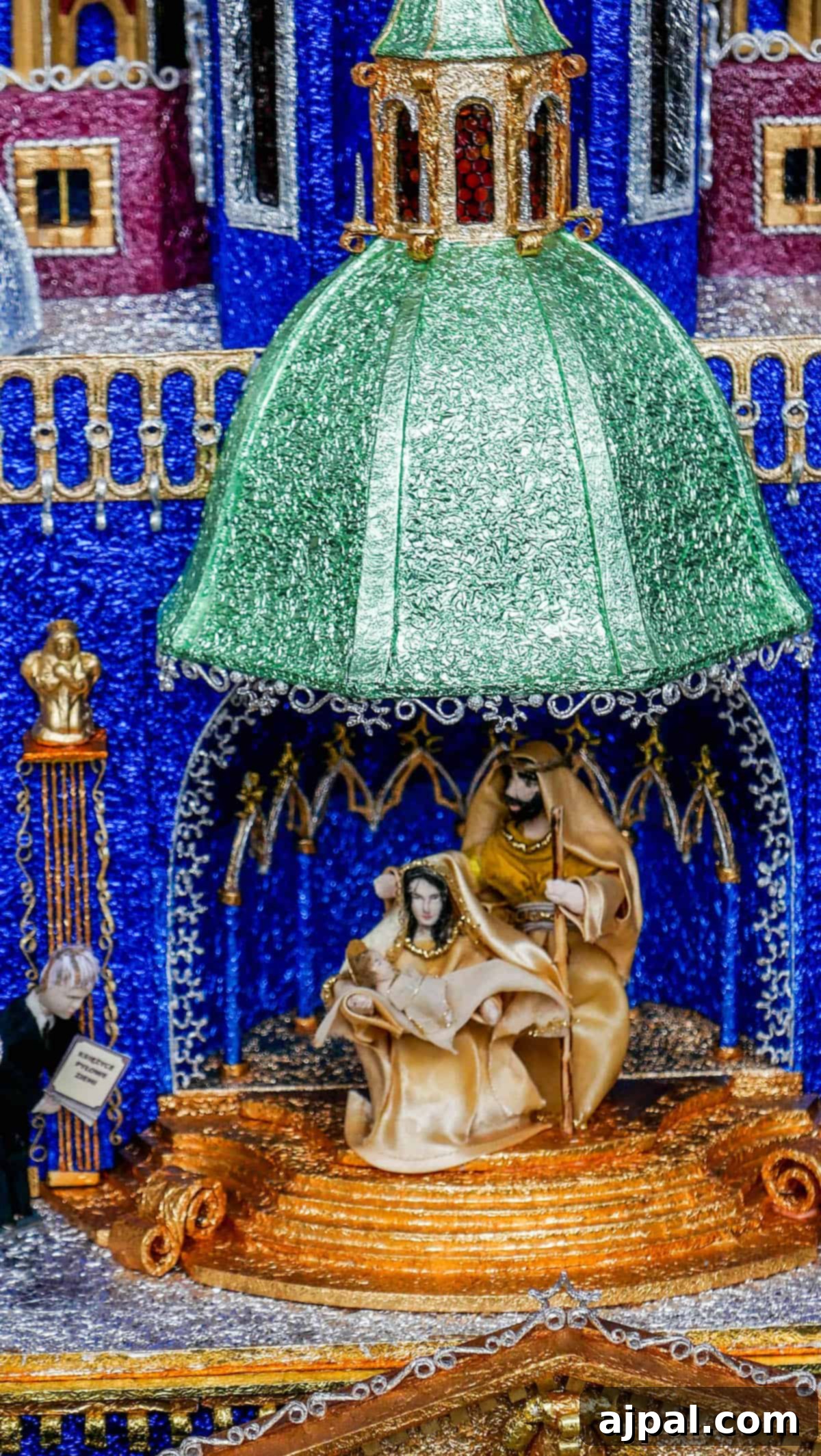 An exquisite nativity scene featuring Mary, Joseph, and baby Jesus under a green dome, set against a vibrant backdrop reminiscent of entries in the Krakow Nativity Competition.