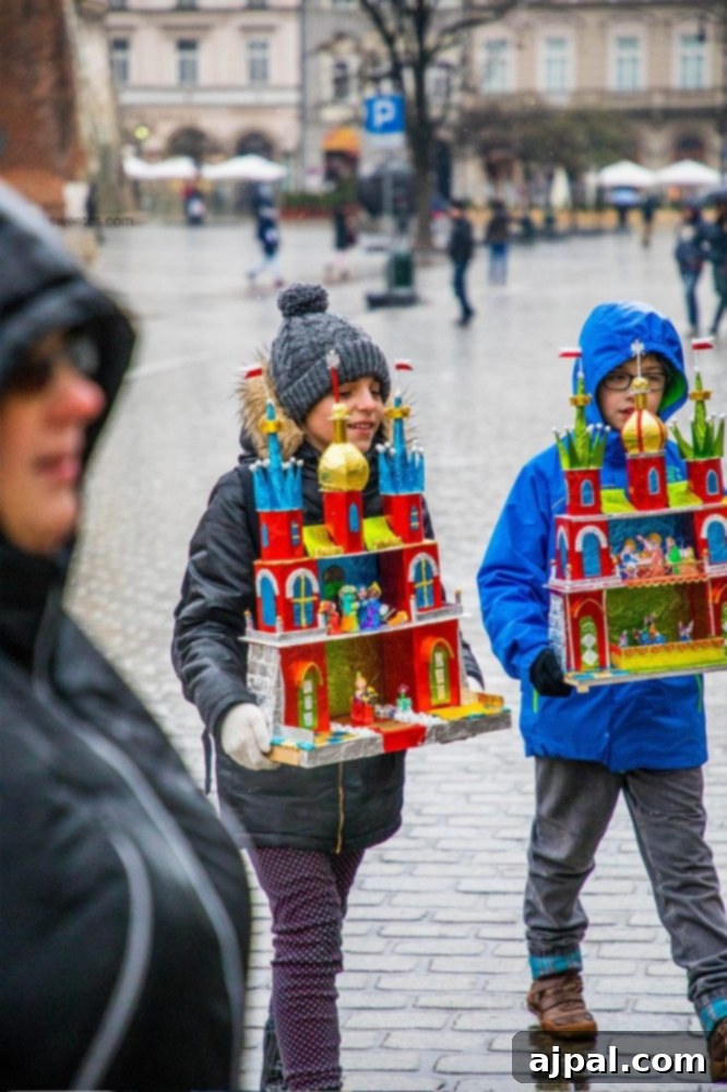 Two children participating in the Krakow Nativity Competition, carrying toy houses through a rainy city.