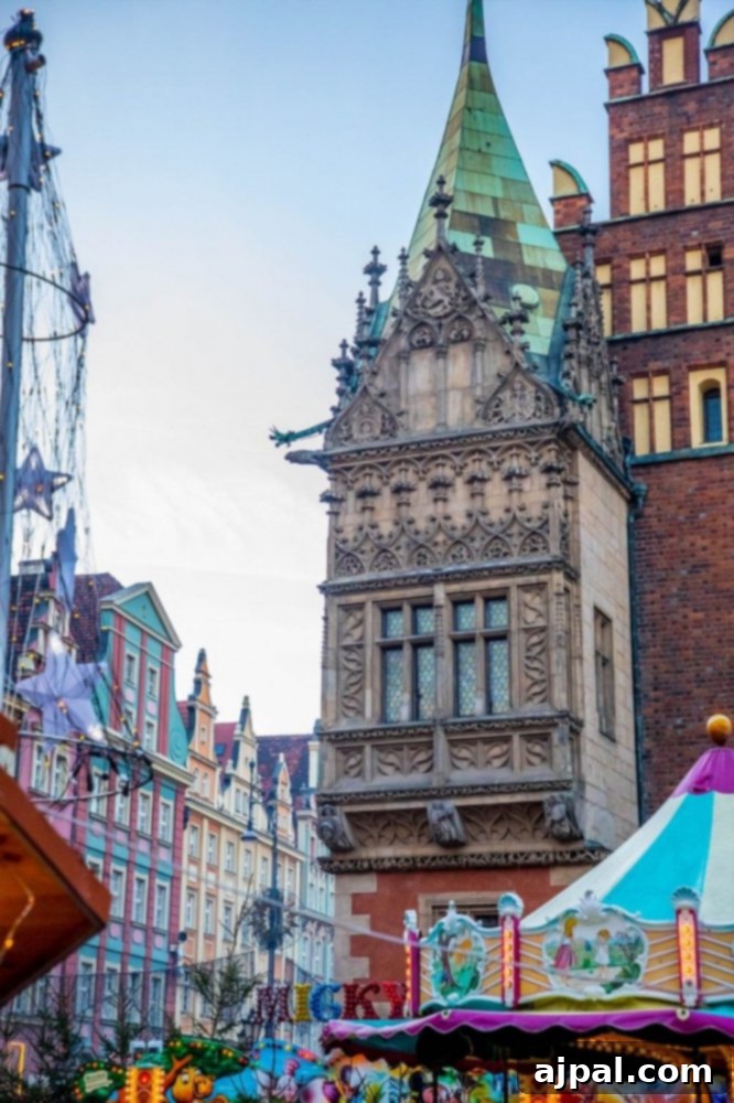 A children's ride or attraction at the Wroclaw Christmas Market, with festive buildings in the background.