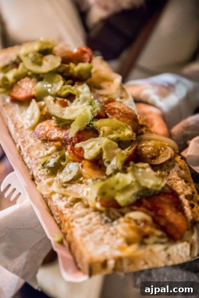 A person holding a large pizza, a popular savory offering at the Wroclaw Christmas Market.
