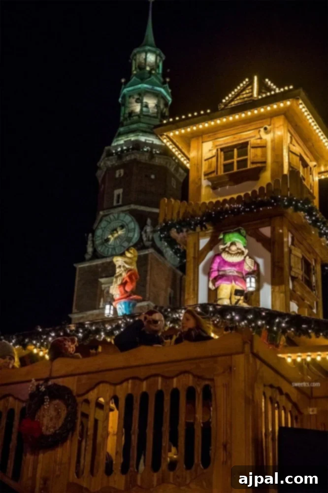 A traditional Grzaniec (mulled wine) stand at the Wroclaw Christmas Market, with a historic clock tower in the background.