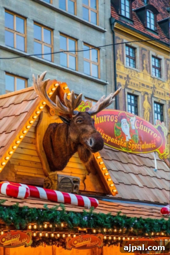 A festive stall at the Wroclaw Christmas market featuring a unique deer head decoration adorned with lights on the roof.