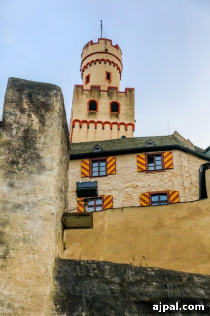 Marksburg Castle: Germany's Best-Preserved Medieval Gem 2 The iconic clock tower of Marksburg Castle rising against the sky, a symbol of its enduring medieval history in Germany.