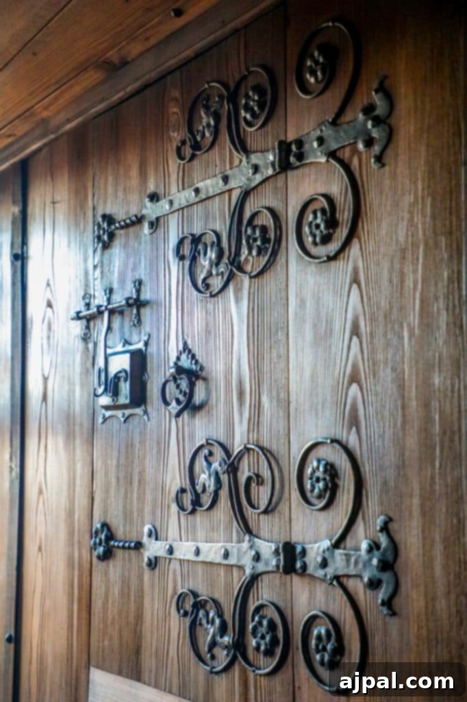 Marksburg Castle: Germany's Best-Preserved Medieval Gem 4 Intricate wrought iron door handles adorn a robust wooden entrance at Marksburg Castle, highlighting medieval craftsmanship.