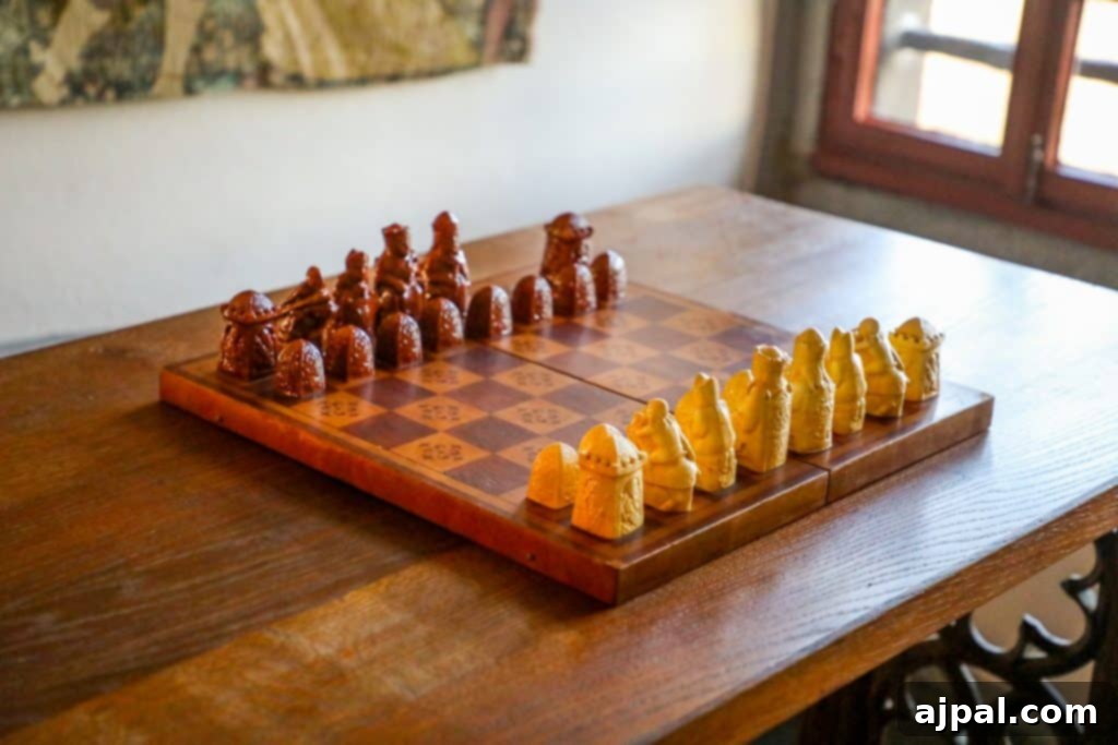Marksburg Castle: Germany's Best-Preserved Medieval Gem 8 An antique wooden chess board displays historic, ornate chess pieces, capturing the intellectual pursuits within Marksburg Castle's servants' kitchen.