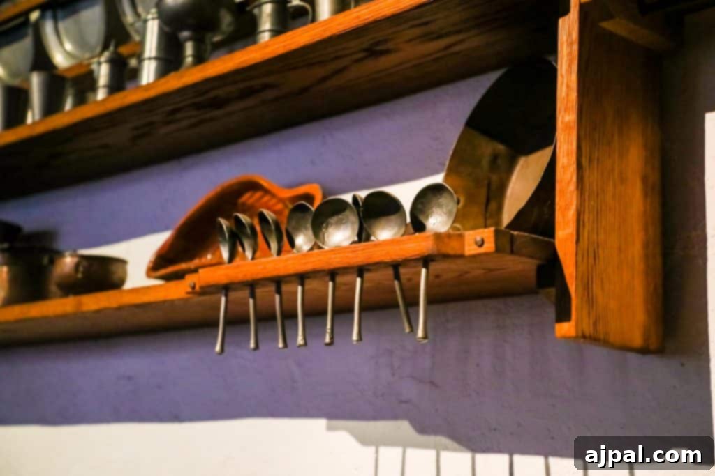 Marksburg Castle: Germany's Best-Preserved Medieval Gem 9 A rustic wooden shelf adorned with various spoons and kitchen utensils, an authentic glimpse into the past at Marksburg Castle.