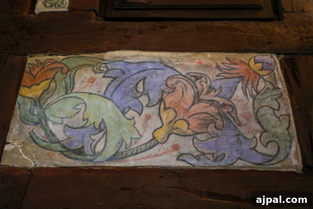 Marksburg Castle: Germany's Best-Preserved Medieval Gem 10 An exquisite painting of vibrant flowers graces a historic wooden wall, inspired by the artistry found within Marksburg Castle.