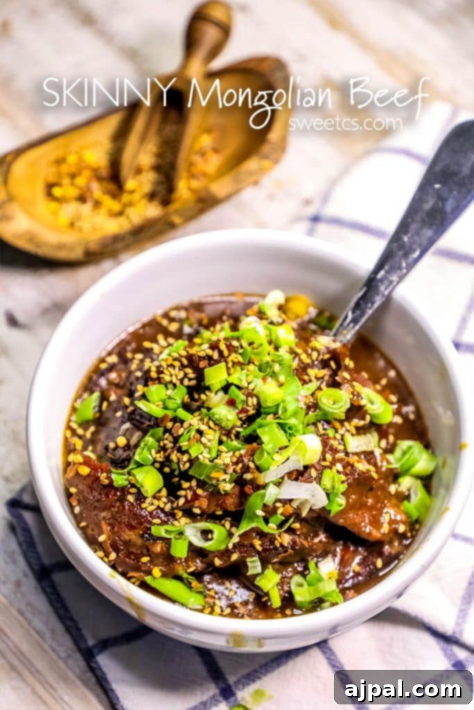 A close-up shot of a bowl brimming with flavorful Mongolian beef stew, generously topped with fresh green onions and sesame seeds. A spoon is ready for tasting, and a linen towel rests gently in the background, creating a rustic and inviting scene.