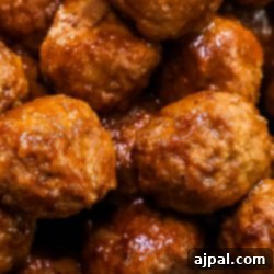 Whiskey BBQ Meatballs in a white bowl on a table.