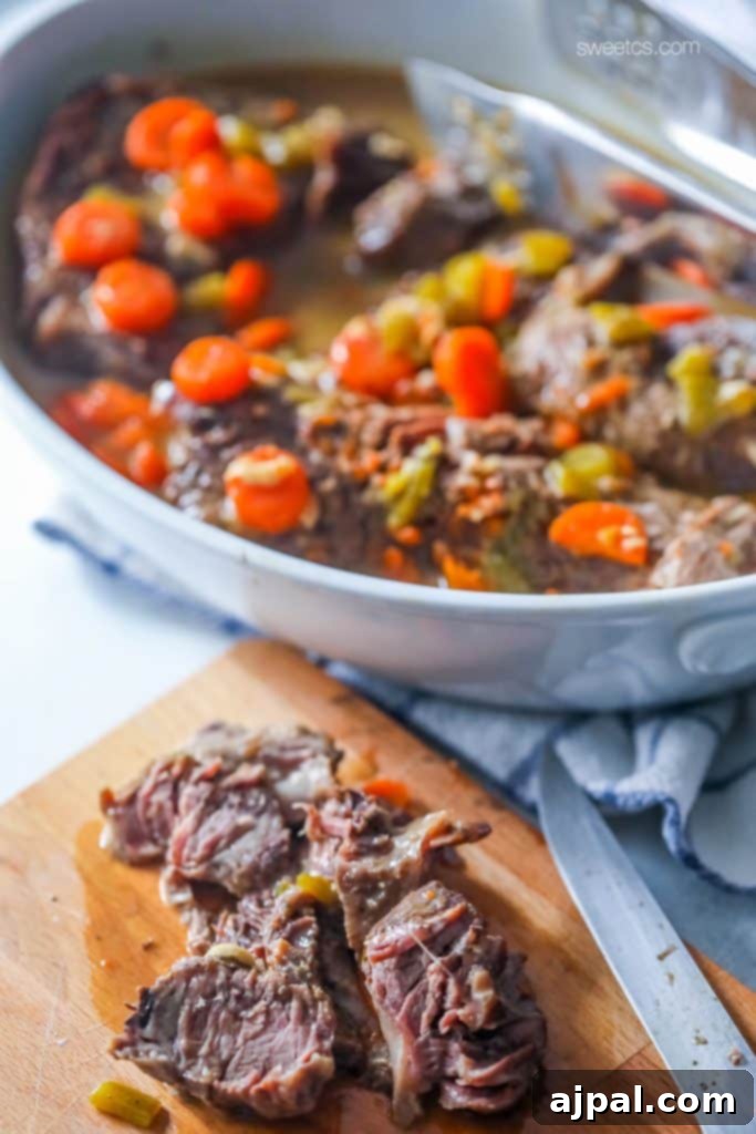 Sliced Instant Pot beef ranch pot roast with tender carrots and gravy, a perfect weeknight meal.