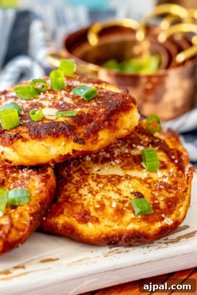 A plate featuring a perfect stack of Irish potato pancakes, garnished simply and ready to eat.