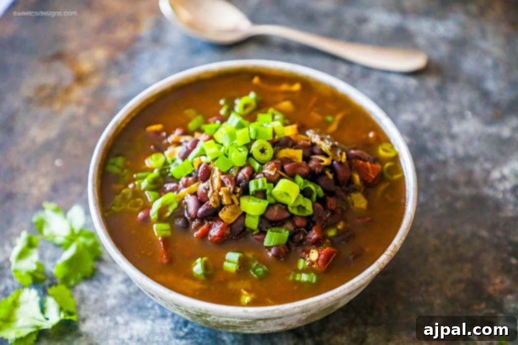 A vibrant and spicy black bean soup in a bowl, with a rich, savory aroma, ready to be enjoyed.