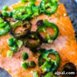 Honey lime jalapeno salmon with peppers on a plate.