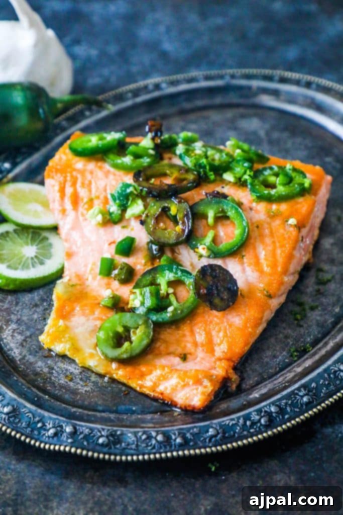 Honey Lime Glazed Jalapeno Salmon 4 A vibrant plate of honey lime jalapeno salmon, garnished with fresh herbs and lime wedges, emphasizing its delicious appeal.