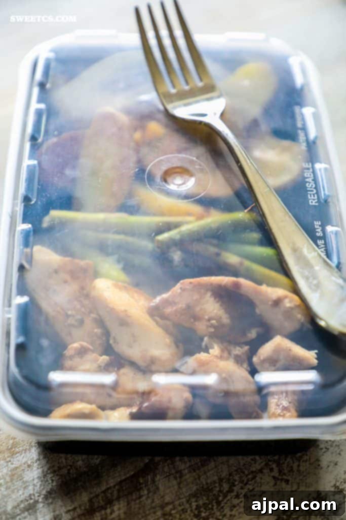Stacked meal prep containers with Instant Pot Balsamic Chicken, asparagus, and potatoes, ready for the week.