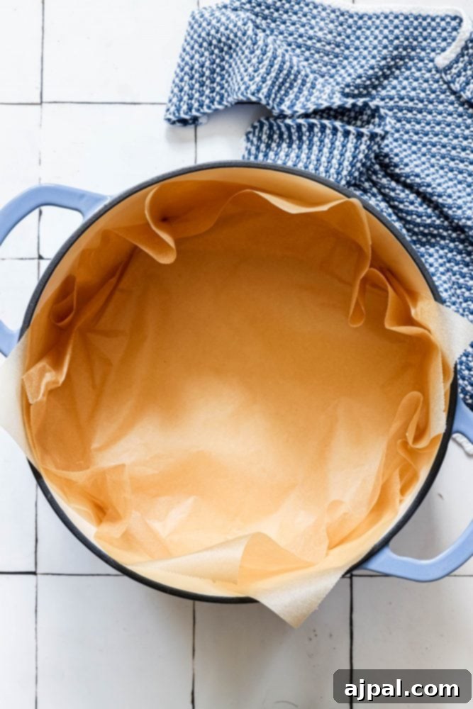 Effortless No-Knead Bread 15 A Dutch oven lined with parchment paper, prepared for baking no-knead bread.