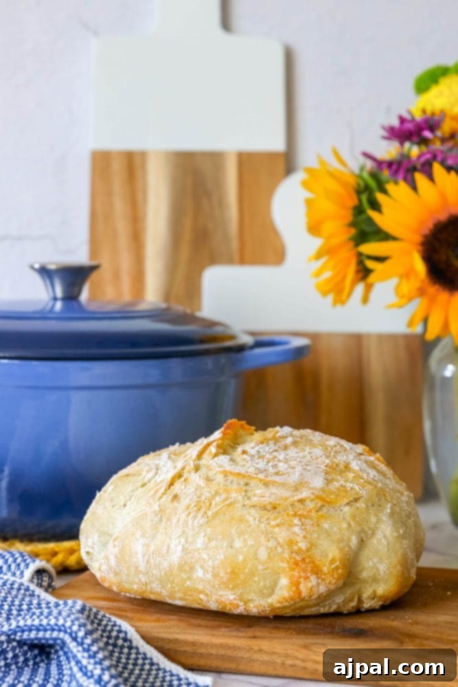 Effortless No-Knead Bread 20 A golden-crusted loaf of no-knead bread on a wooden cutting board, flanked by vibrant sunflowers, emphasizing its natural beauty.