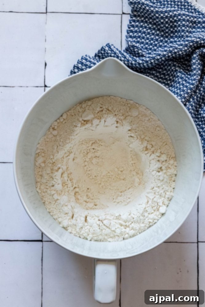 Effortless No-Knead Bread 8 A well formed in the center of flour in a mixing bowl, preparing for liquid ingredients.
