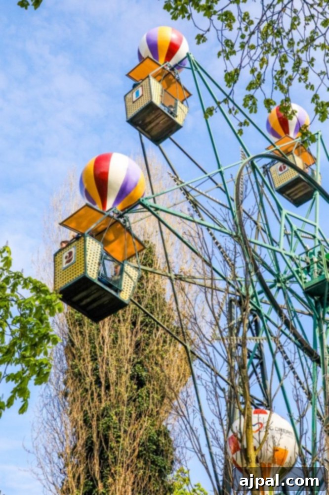 Tivoli Gardens Copenhagen Wonderland 14 The enchanting Tivoli Gardens Ferris wheel, adorned with colorful hot air balloons, creating a whimsical scene.