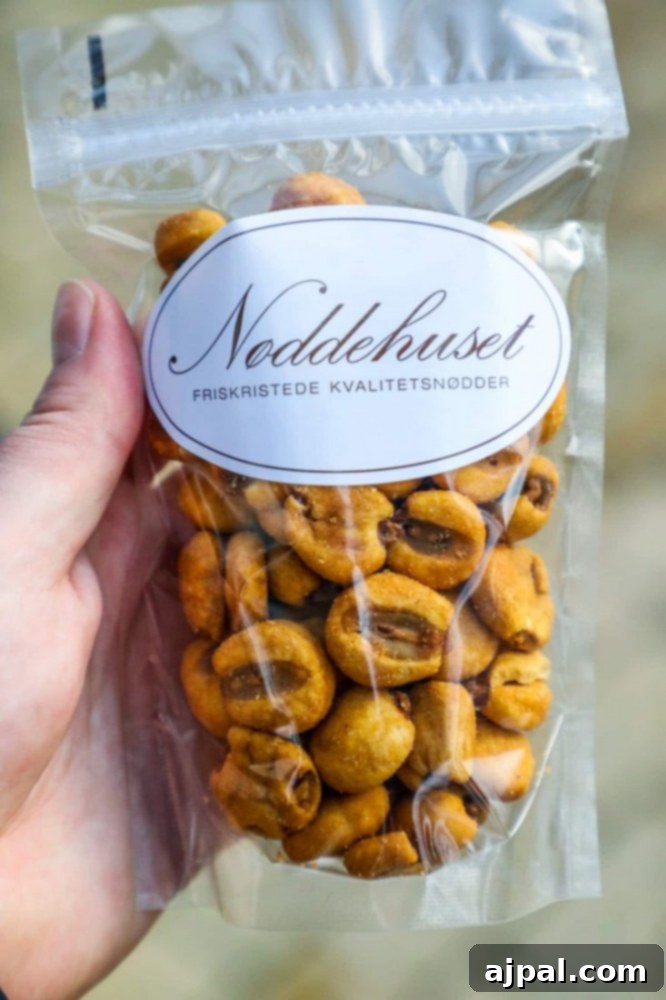 Tivoli Gardens Copenhagen Wonderland 21 A person enjoying a bag of delicious nuts while exploring Tivoli Gardens, Copenhagen.