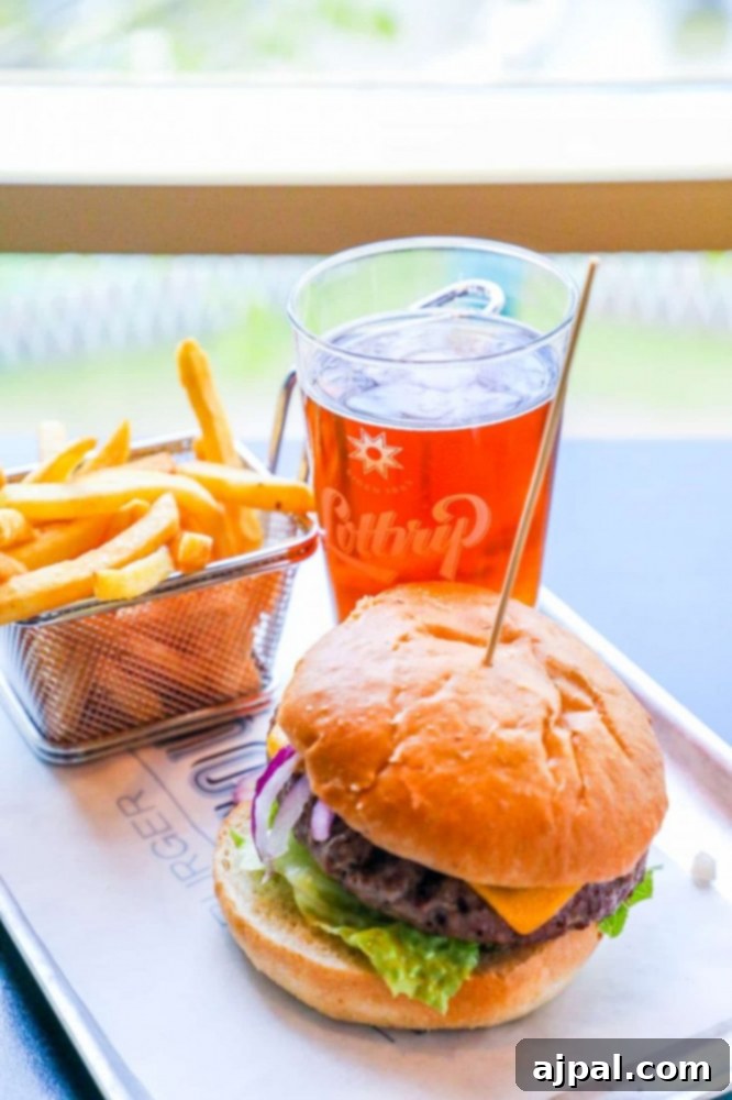 Tivoli Gardens Copenhagen Wonderland 24 A classic meal tray with a juicy hamburger, crispy fries, and a refreshing drink at Tivoli Gardens.