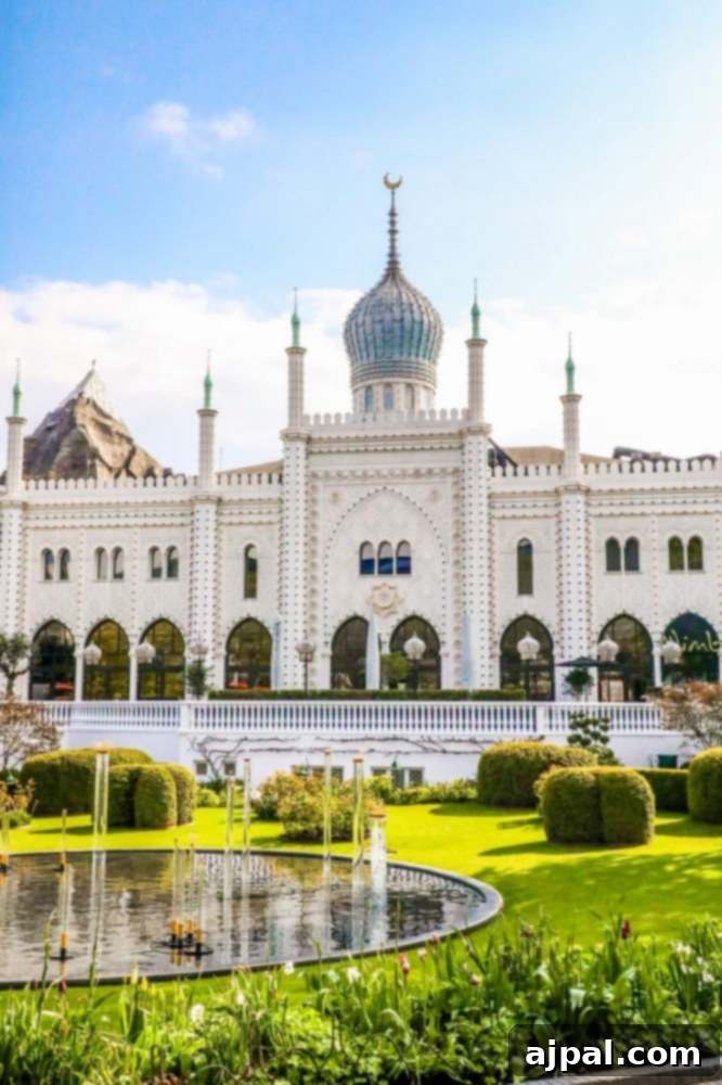 Tivoli Gardens Copenhagen Wonderland 26 An elegant white building with a classical fountain in front, typical of Tivoli Gardens' charm.