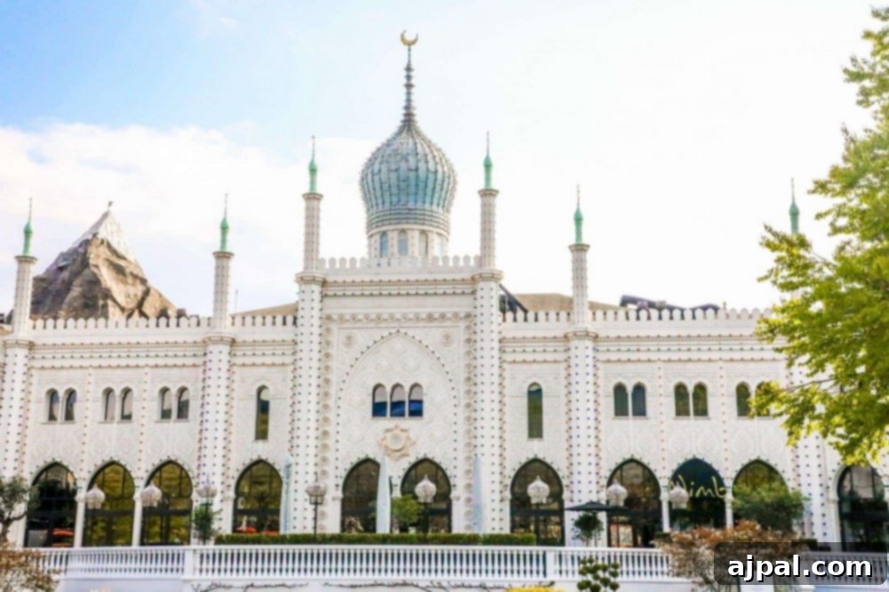 Tivoli Gardens Copenhagen Wonderland 27 A majestic white building topped with a grand dome, a striking feature of Tivoli Gardens, Copenhagen.