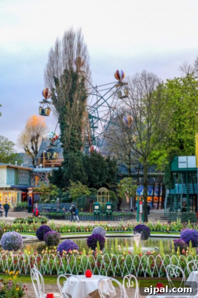 Tivoli Gardens Copenhagen Wonderland 10 The iconic Ferris wheel illuminated at night, a timeless attraction in Tivoli Gardens, Copenhagen.