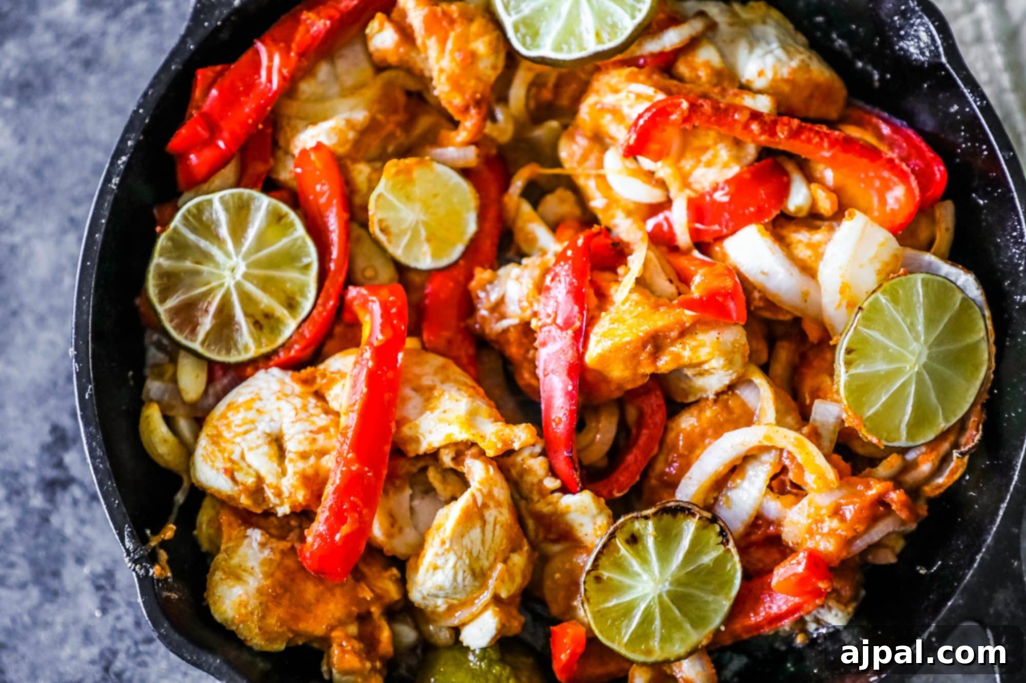 One Pan Baked Chicken Fajitas 3 Sizzling chicken, bell peppers, and lime wedges fresh out of the skillet