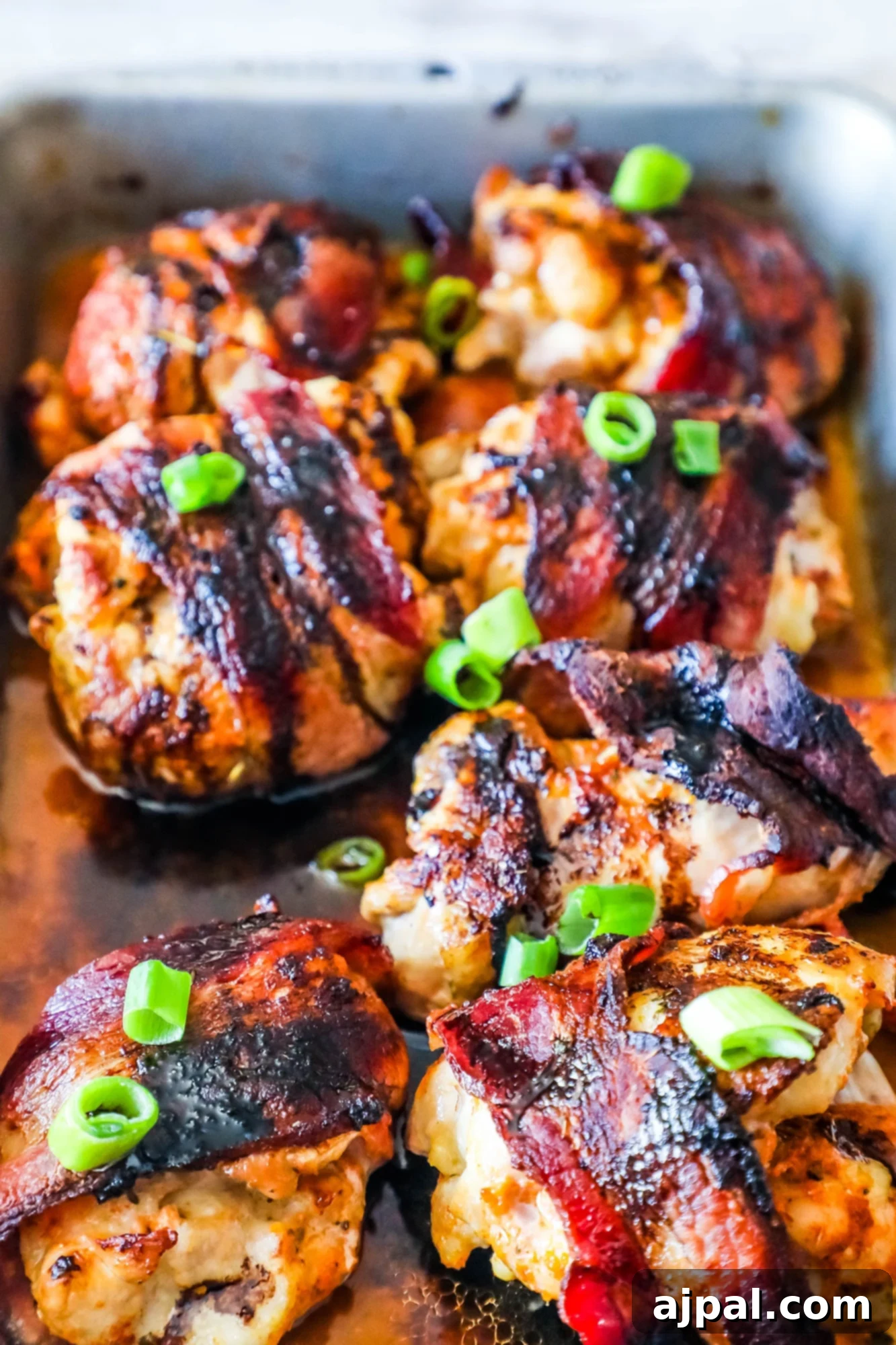 Sweet and Savory Balsamic Bacon Chicken Thighs 4 Delicious balsamic bacon glazed chicken thighs, perfectly cooked and served.
