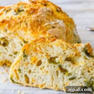 baked bread round with peppers and cheese cut in half on a table