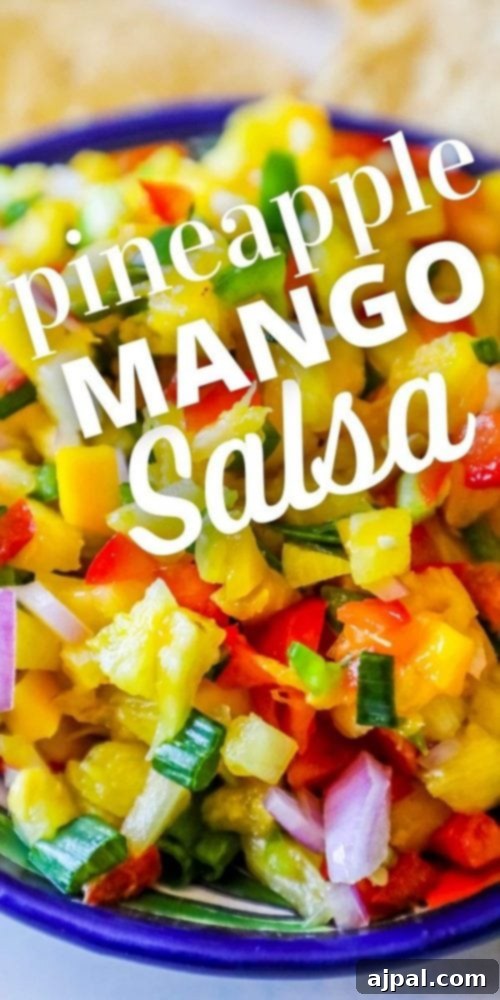bowl with pineapple, jalapeno, red onion, and green onions, chips behind it