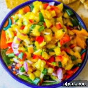 A bowl of easy fruit salsa with tortilla chips.