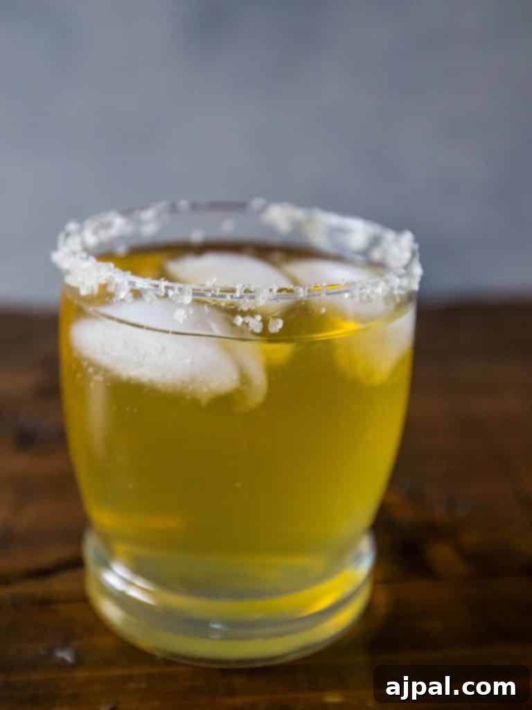 A refreshing Beer-ita cocktail in a salt-rimmed glass, garnished with lime, perfect for a sunny day.