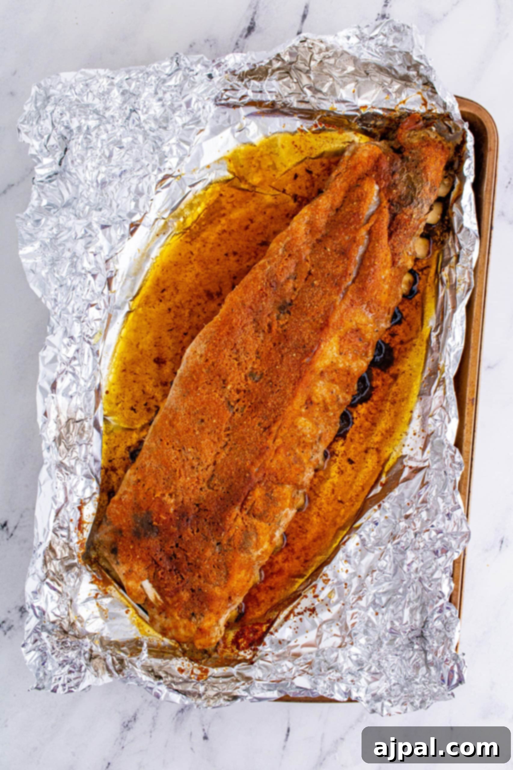 Perfectly Tender Oven Baked Ribs 8 Close-up of ribs generously seasoned with a dry rub, showcasing the rich texture and even spice coverage.