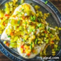 A plate of Baked Hawaiian Chicken with salsa and peppers on it.