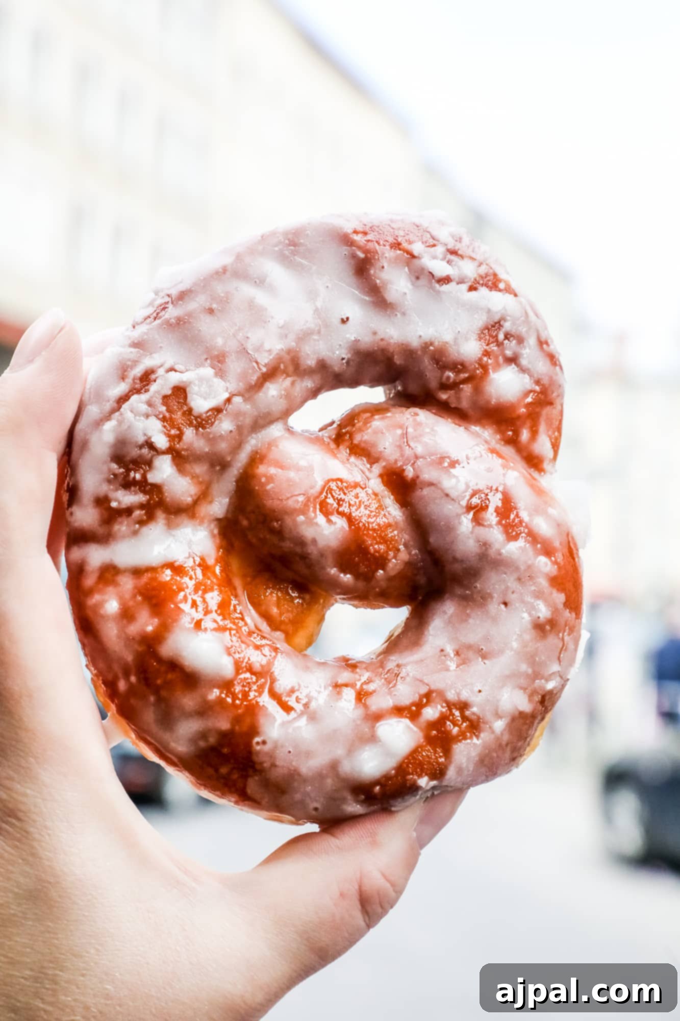 A person is holding a doughnut in their hand in Berlin.