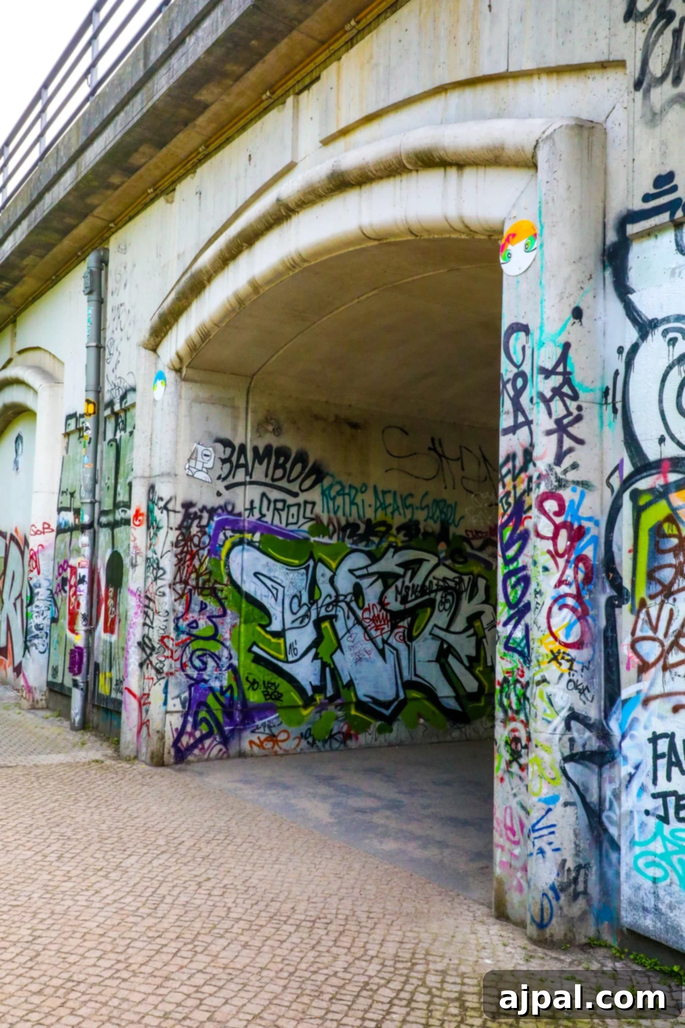 A bridge in Berlin covered entirely in vibrant and intricate graffiti art.