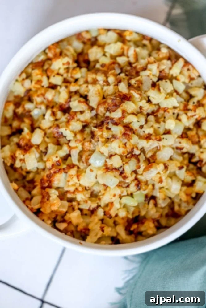 browned cauliflower rice in a white bowl.
