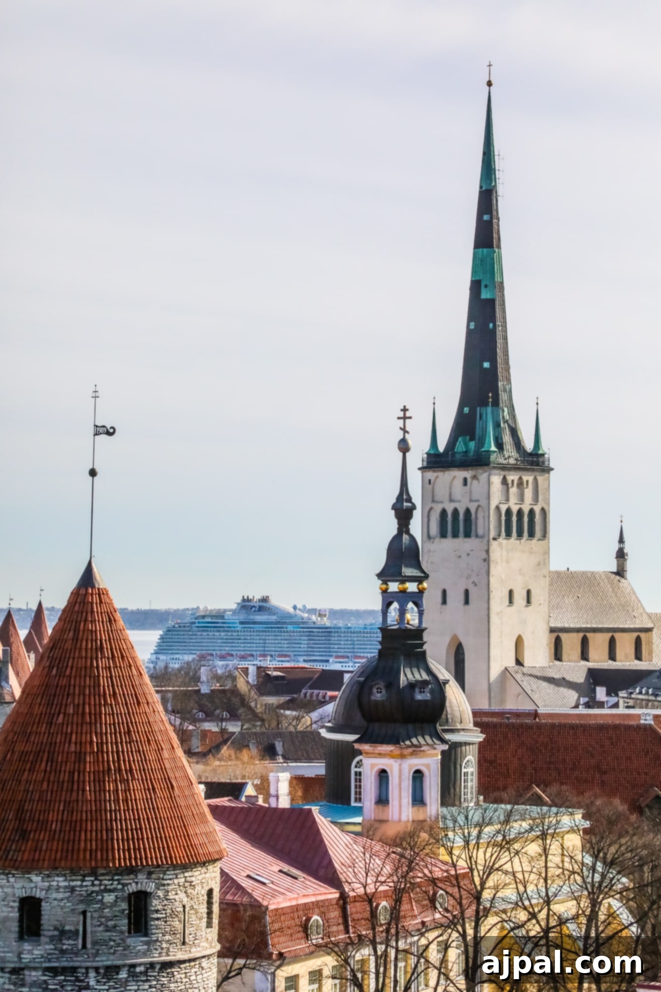 An enchanting panoramic view of Tallinn's historic Old Town with colorful buildings and a church steeple, a perfect representation of a Tallinn travel diary.