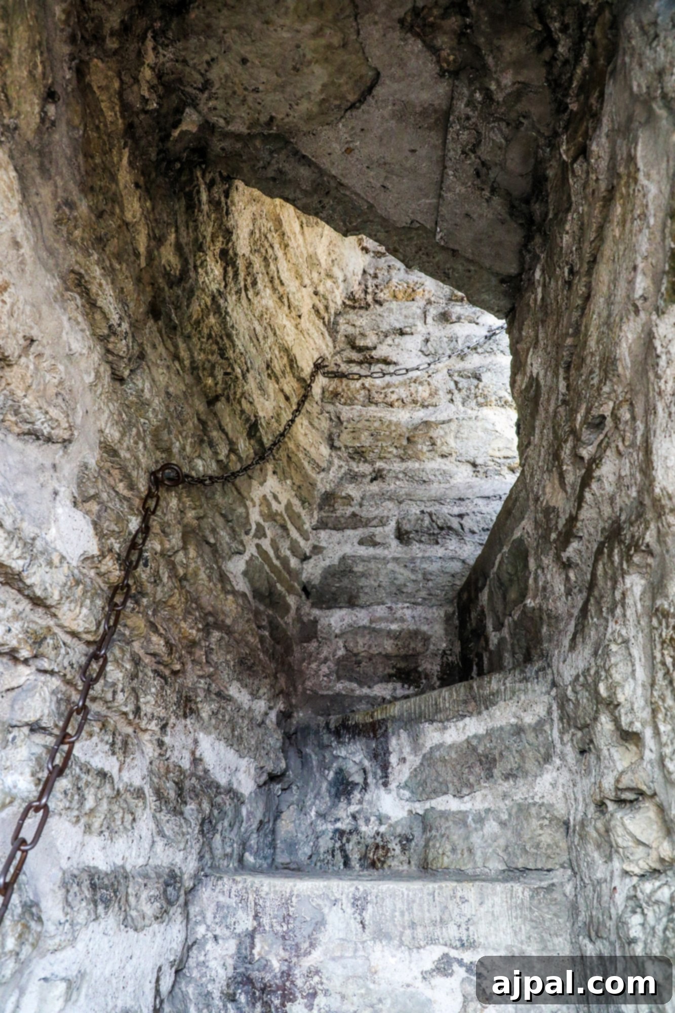 Steep, winding steps leading up into a historic stone tower in Tallinn, Estonia, inviting exploration of its medieval past.