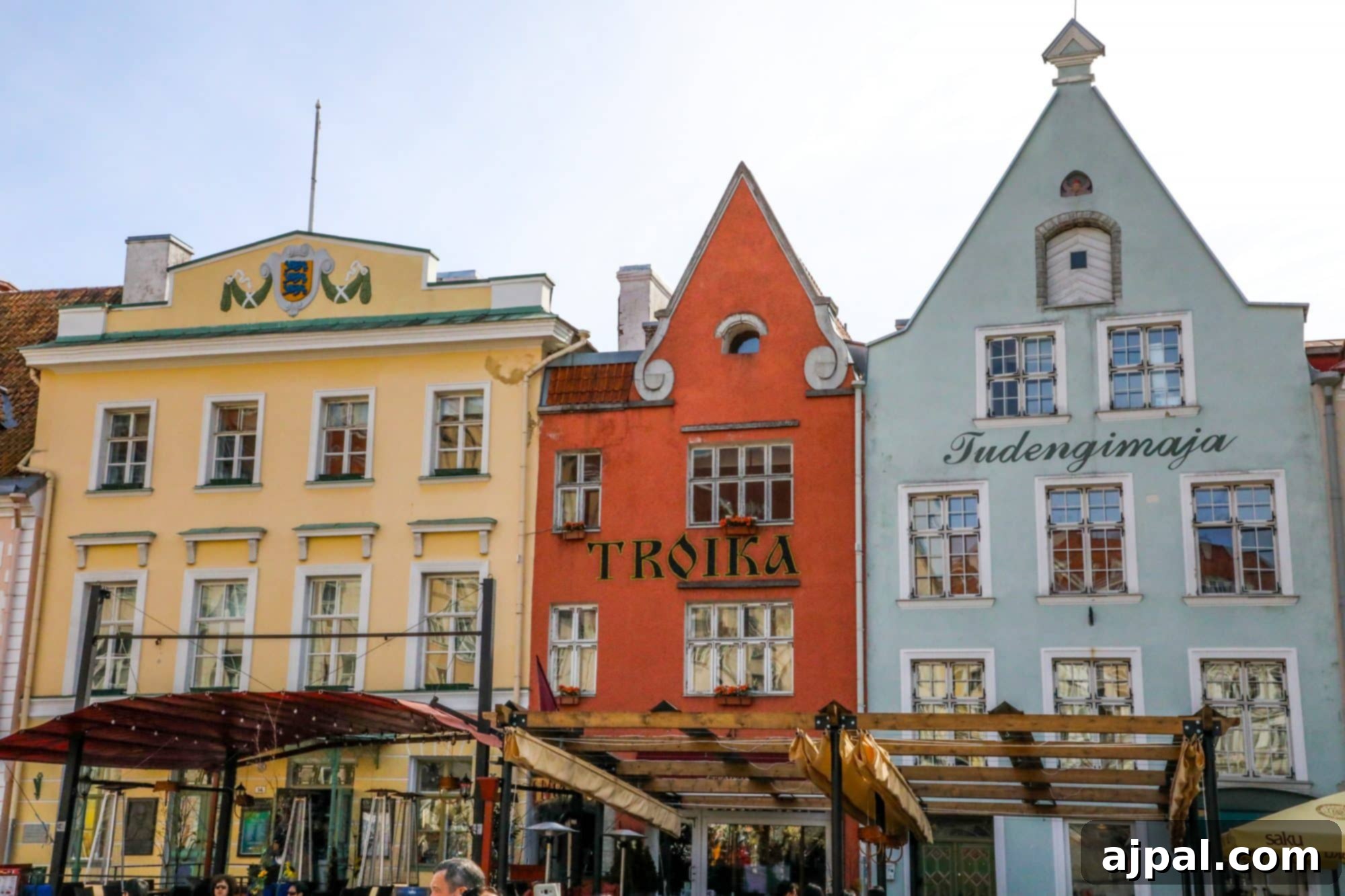 The lively Market Square in Tallinn, Estonia's Lower Old Town, surrounded by colorful buildings and bustling activity.