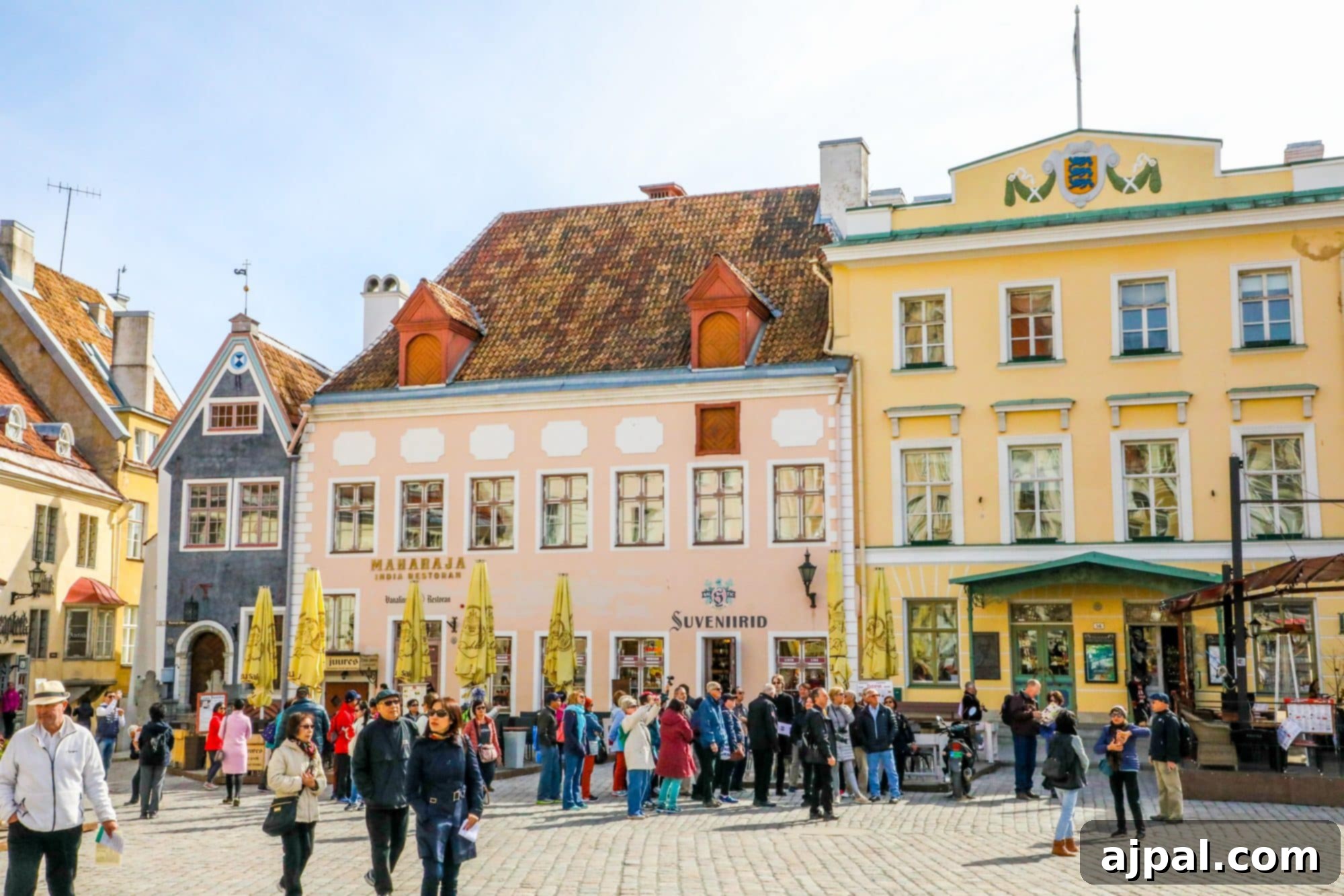 A vibrant scene of Tallinn's Market Square, showcasing historic architecture, outdoor seating, and a lively atmosphere.