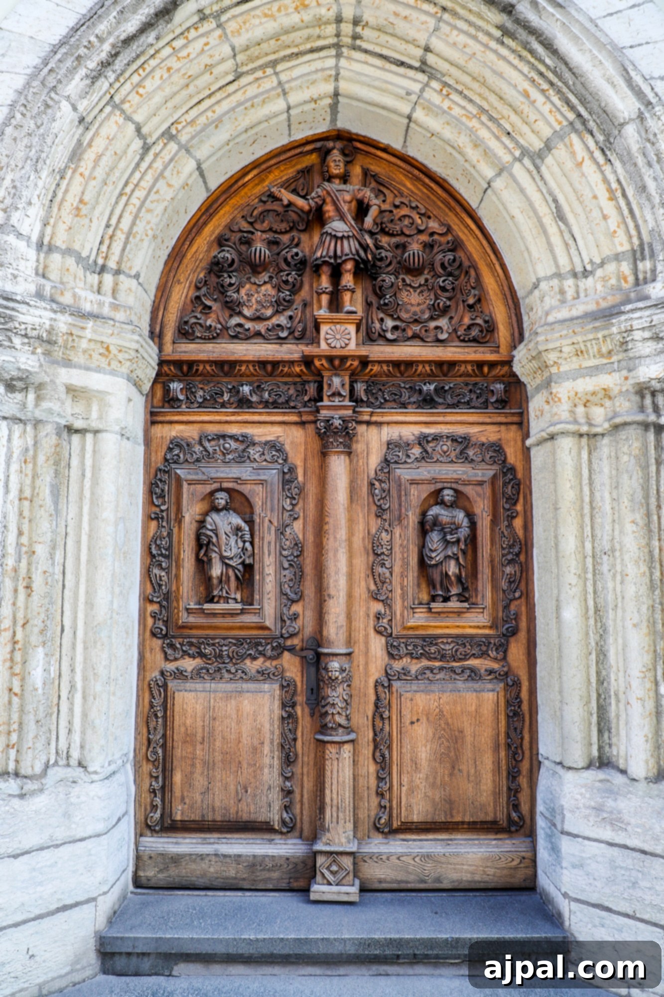 An intricately carved wooden door in Tallinn, Estonia, showcasing detailed craftsmanship and historical elegance.