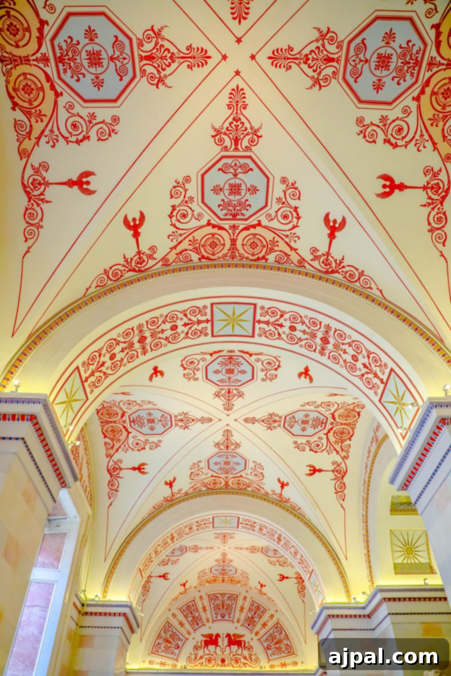 An ornately decorated ceiling within a historical building in Saint Petersburg, Russia.