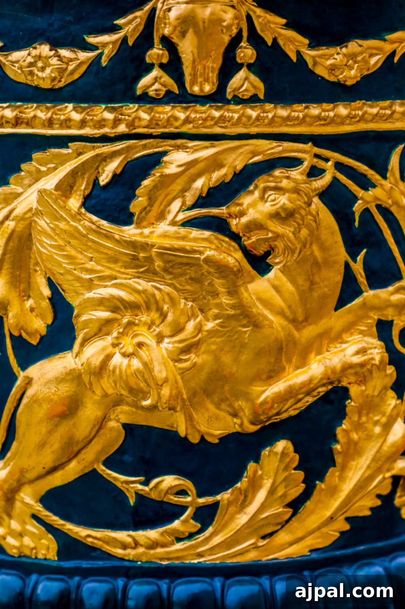 An intricate detail on an urn featuring a gold lion against a blue background, part of the Hermitage Museum in Russia and the Ultimate Saint Petersburg Shore Excursion.