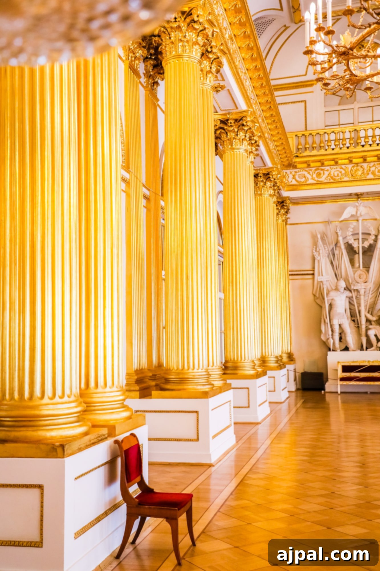 A grand room adorned with golden pillars and a regal chair, a splendid sight on a Princess Cruises Saint Petersburg shore excursion through the Hermitage Museum.