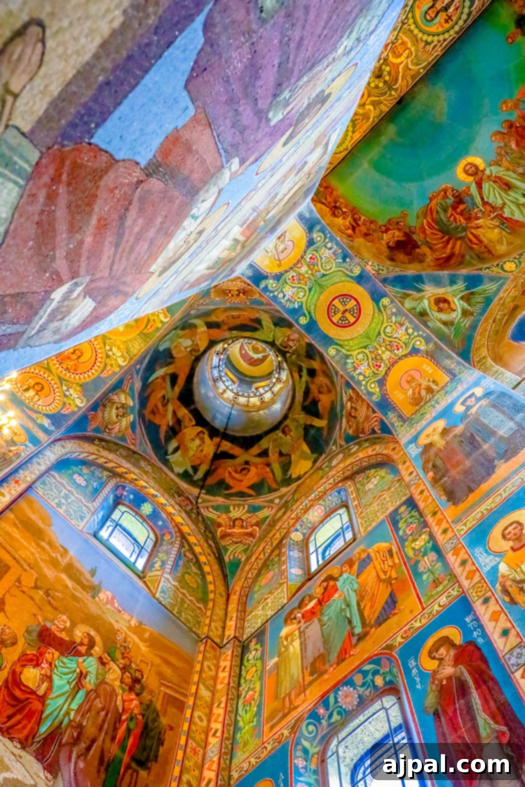 The stunning interior of a church with vibrant, colorful paintings adorning its ceiling, captured during a Saint Petersburg tour.