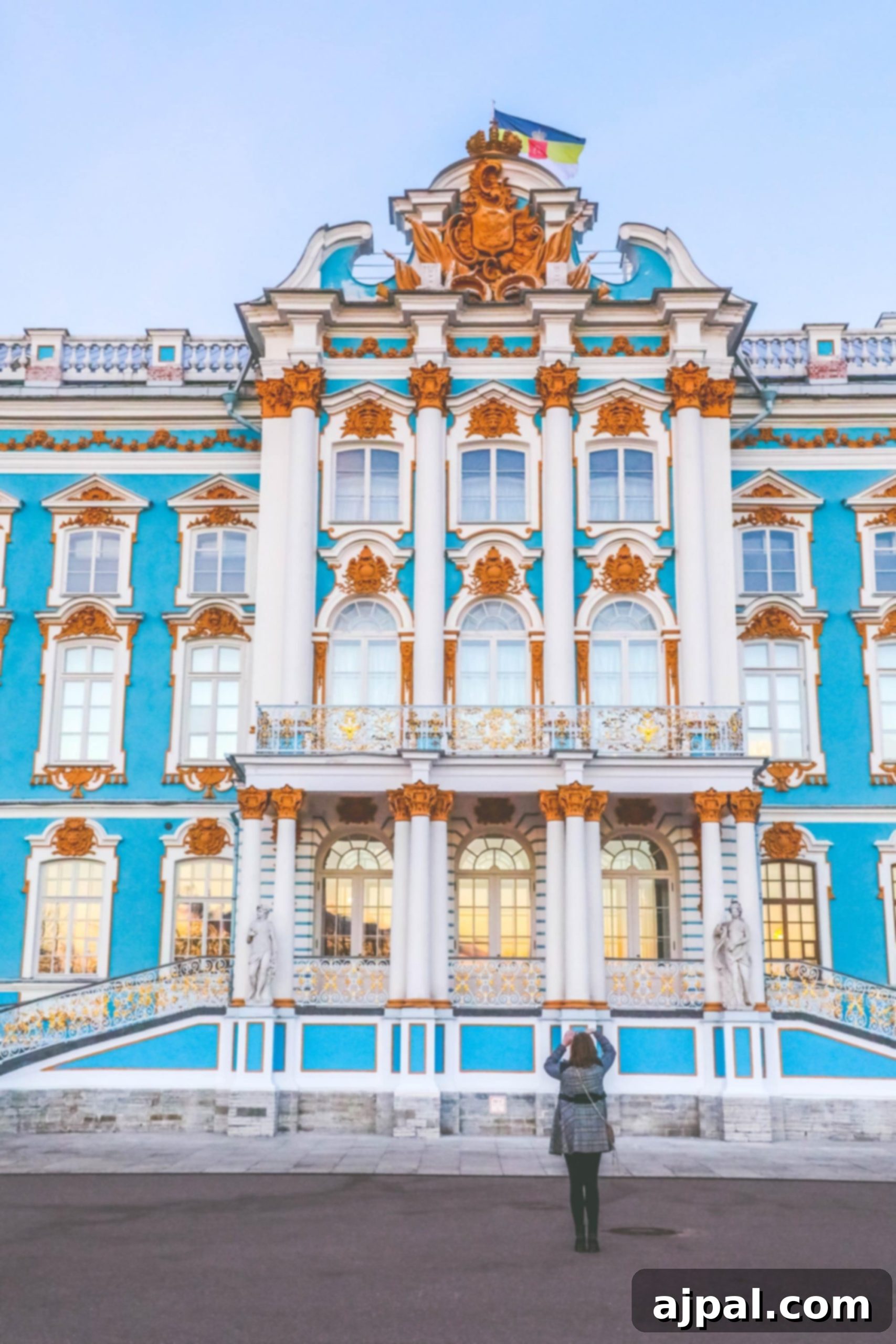 A woman admires the majestic blue and gold architecture of Catherine's Palace during a Princess Cruises Saint Petersburg shore excursion.