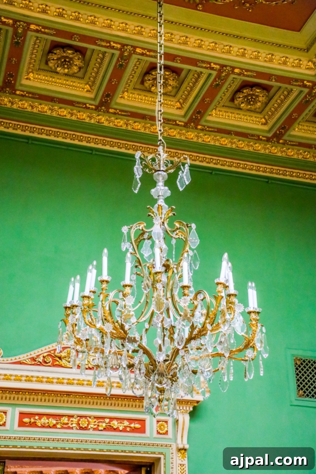 An ornate chandelier hangs elegantly in a green room within the Yusupov Palace, part of the Princess Cruises Ultimate Saint Petersburg Shore Excursion in Russia.